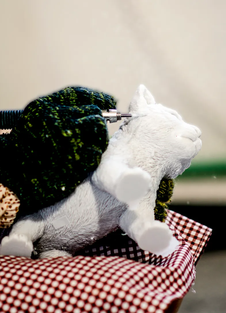 The finishing touches applied to a cat figurine